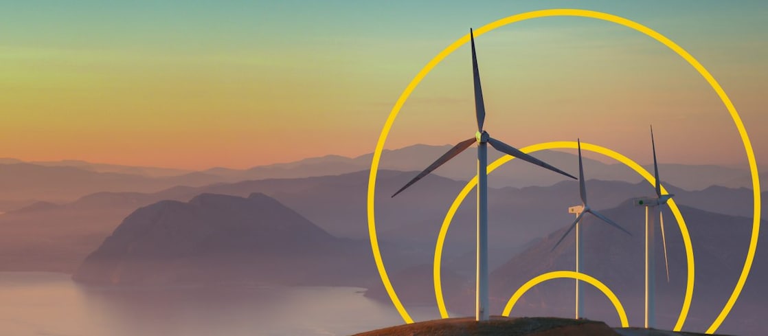 Photo of three wind turbines on a hill with an outline of the Achieving net-zero emissions graph