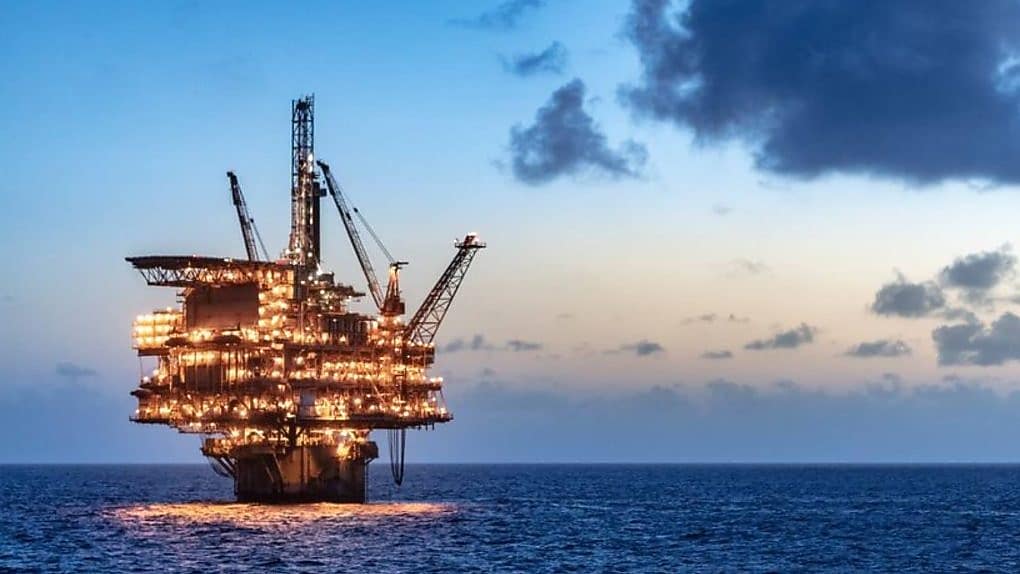 Offshore oil platform in the sea lit up at night
