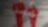 Male and female worker in red overalls and white helmets and hearing protection walking