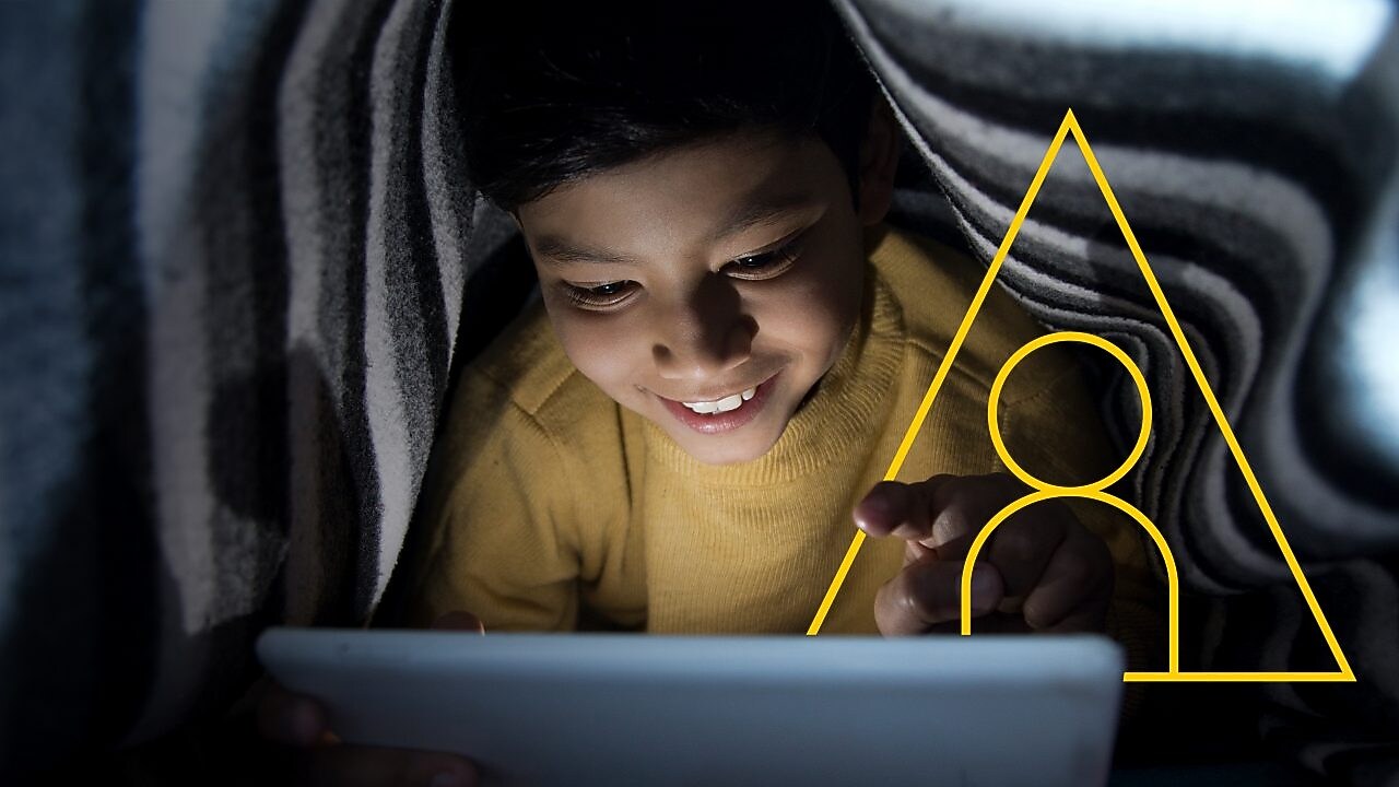 Photo of young boy looking at a tablet with an outline of the Powering lives graph