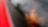 Child looking at a tablet inside a red car.