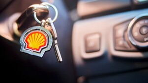 Car key in the ignition with a Shell keychain.
